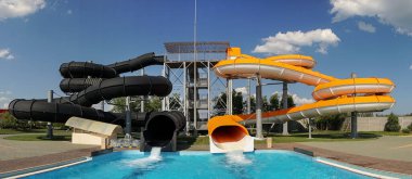 Water park with colorful slides and pools. clipart