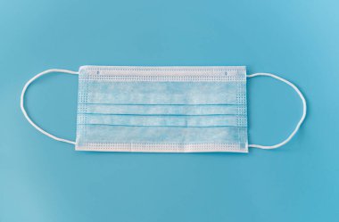 Solunum cihazı mavi arkaplanda. Tıbbi maskeli virüslere ve bakterilere karşı koruma.