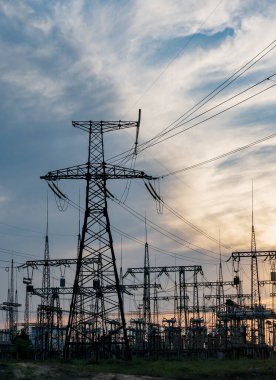 Elektrik hatları ve trafolar olan elektrik santralini gün batımında dağıtın.