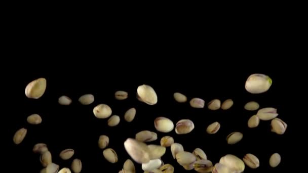 Pistachios are flying on a black background — Stock Video