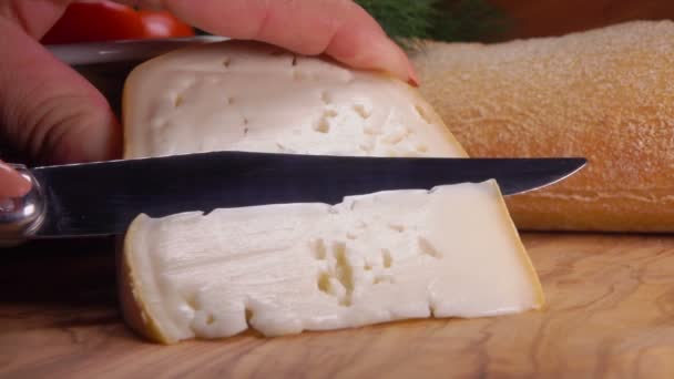 El cuchillo corta un pedazo de queso de oveja suave — Vídeos de Stock