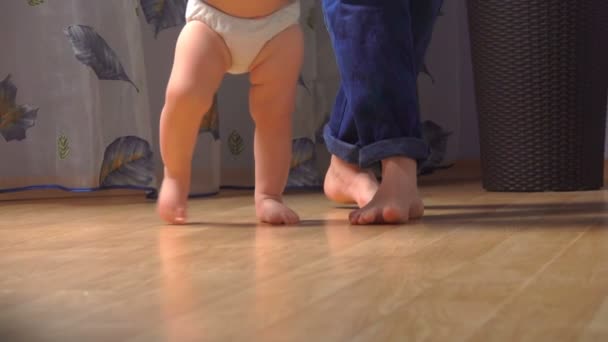 Close-up of childrens legs taking their first steps — Stock Video