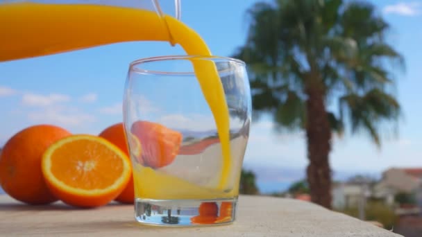 Close-up orange juice poured into a glass — Stock Video