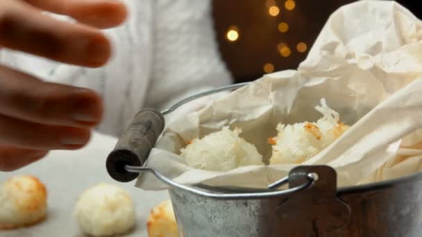 Рука берет кокосовое печенье макароны из кастрюли — стоковое видео