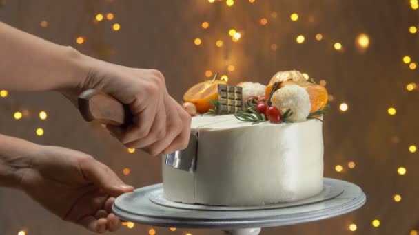 Close-up of a hand with knife cuts new years cake — Stock Video