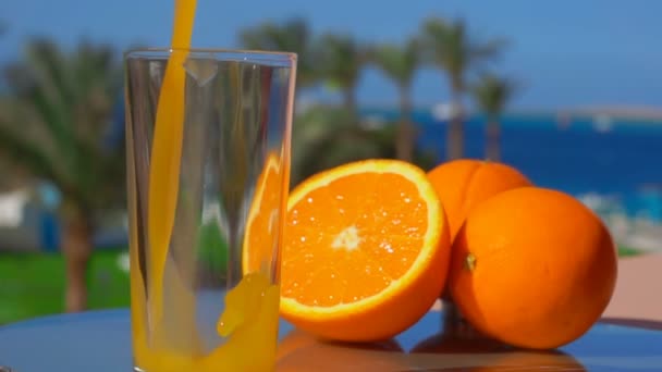 Orange juice poured into a glass — Stock Video