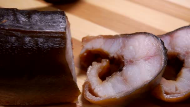Close-up camera movement in pieces of smoked eel — Stock Video