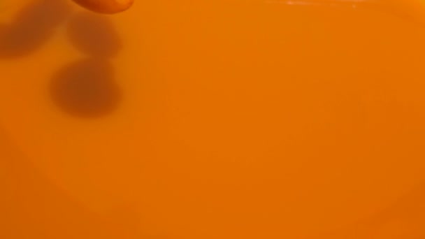 Halves ripe apricots fall into juice — Stock Video