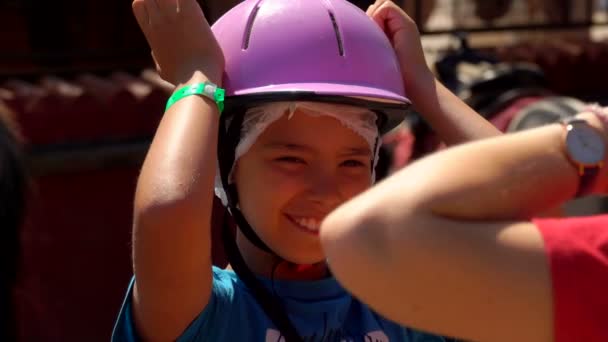 Boy tries on a protective helmet on his head — Stock Video