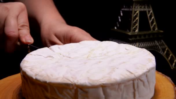 Knife cuts off and pulls out a sector of Camembert — Stock Video