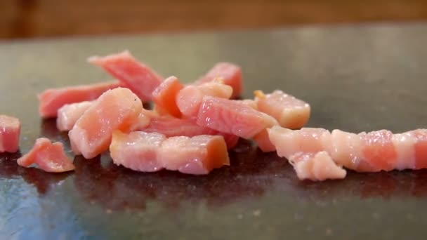 Finely diced bacon falls on the grill — Stock Video