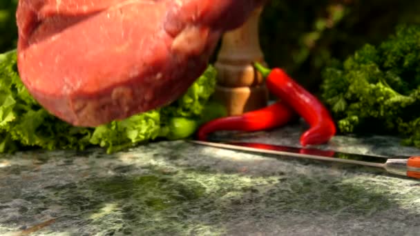 Veal steak falls on a green marble table — Stock Video
