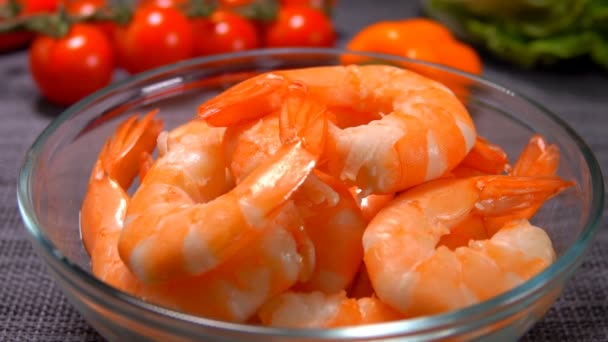 Hand takes tasty large shrimp from a glass bowl — Stock Video