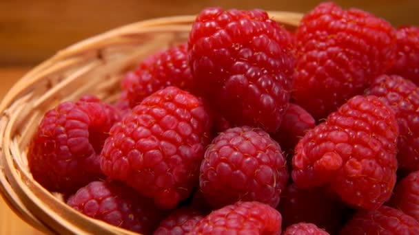 Main prend une grosse framboise hors du panier en osier — Video