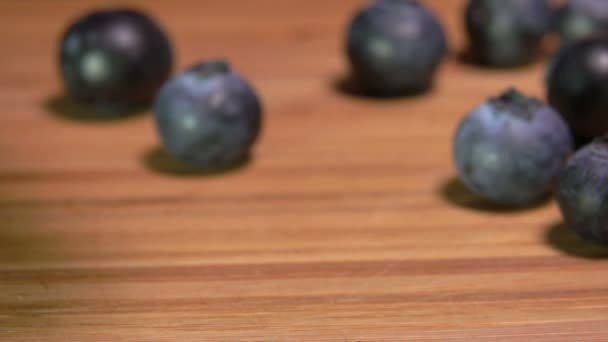 一个巨大的蓝莓在木制表面反弹 — 图库视频影像