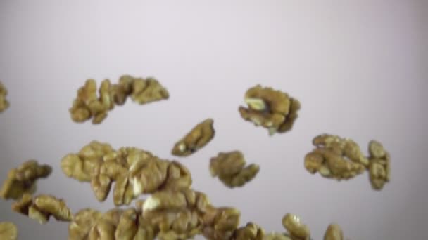 Очищенные грецкие орехи скачут на белом фоне — стоковое видео