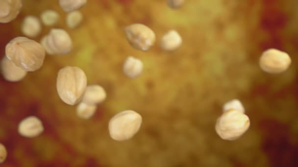 Close up of peeled hazelnuts flying and spinning on the yellow ochre background — Stock Video