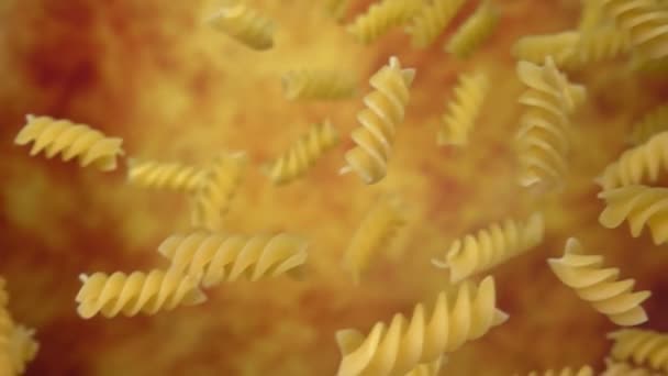Torr pasta fusili flyger diagonalt på en gul ochre bakgrund — Stockvideo