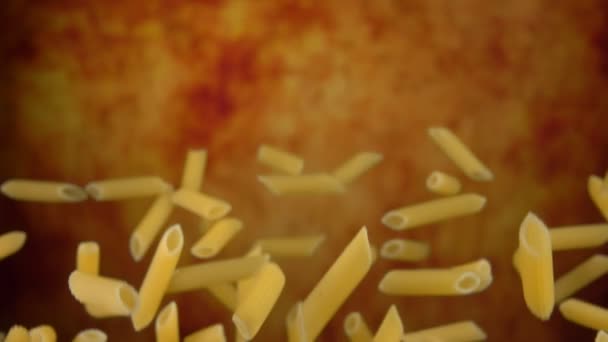 Pasta seca cruda penne volar sobre un fondo ocre amarillo — Vídeo de stock