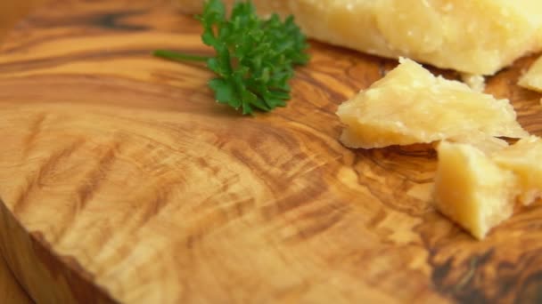 Närbild panorama av hårda parmesanost bitar ligger på träskiva — Stockvideo