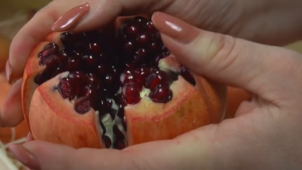 Ruce lámou šťavnatý zralý granátový jablko na šest kousků — Stock video