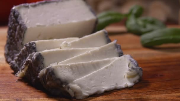 Close-up of delicious soft goat cheese with grey mold cut on triangular pieces — Stock Video