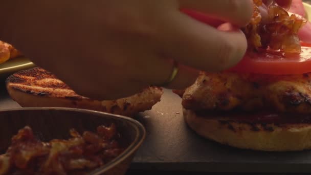 Close-up of the female hands making homemade grilled burger with chicken fillet — Stock Video