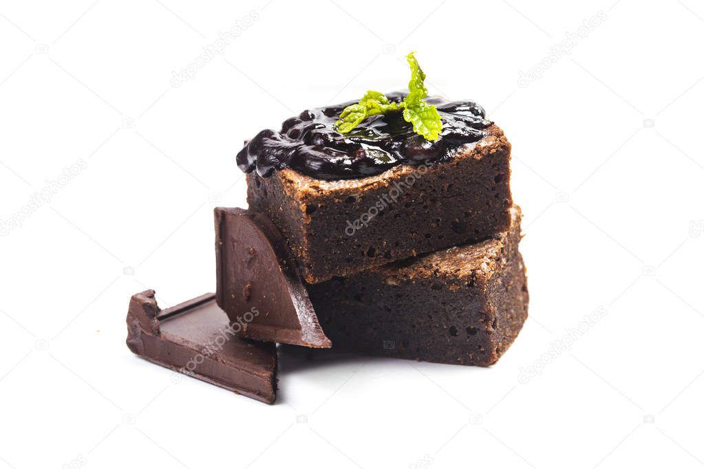Homemade dark chocolate brownies topping with almond slices and mint stacked on wood table with copy space. Delicious bitter sweet and fudge. Brownie is one type of chocolate cake.