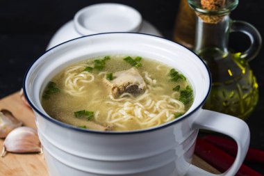 Sofrada erişteli domuz pirzolasından yapılmış lezzetli çorba.