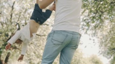 Genç baba ve küçük oğlu açık havada eğlence var. Baba ve oğul parkta oynarken