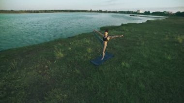 Pratik yoga sabah parkta güzel bir kız. Esmer kadın yoga yaparken