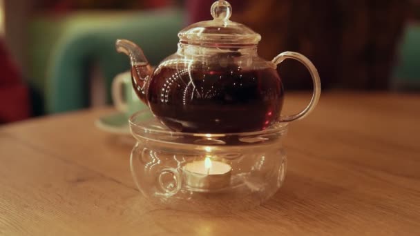 Tea time. Teapot with tea at table