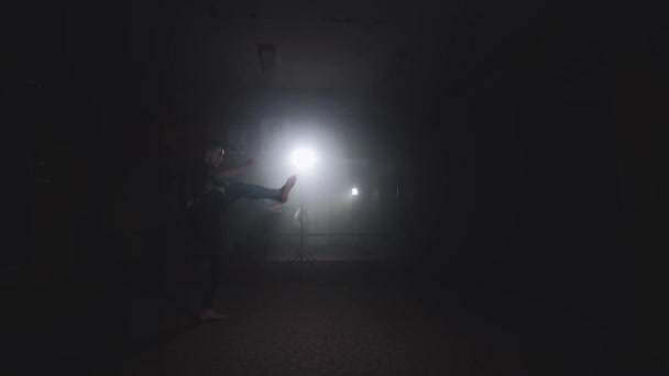 Sportsman boxing in dark gym. Silhouette of Boxer training in smoky studio — Stock Video