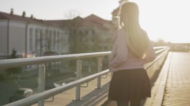 Gündoğumu veya günbatımı şehirde yürüyüş uzun saçlı güzel kadın portresi