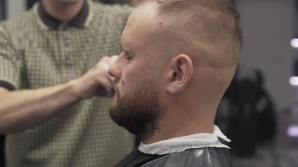 Peluquero macho recortando barba con afeitadora. Barbero barba de afeitar con afeitadora eléctrica — Vídeos de Stock