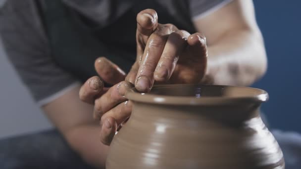 Hands gently create correctly shaped handmade from clay. Potter creates product — Stock Video