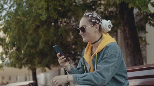 Young Smiling Woman Using Smartphone Sitting Bench Copy Space Female — Αρχείο Βίντεο