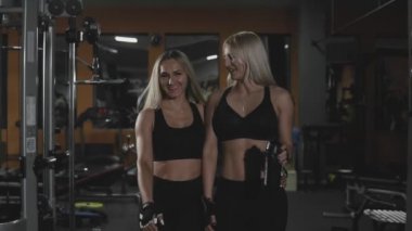 Dolly, spor salonunda birlikte yürüyen cheeful genç kızların vurdu. Yavaş hareket Gym giren atletik kadınların takip shot. Ön görünüm