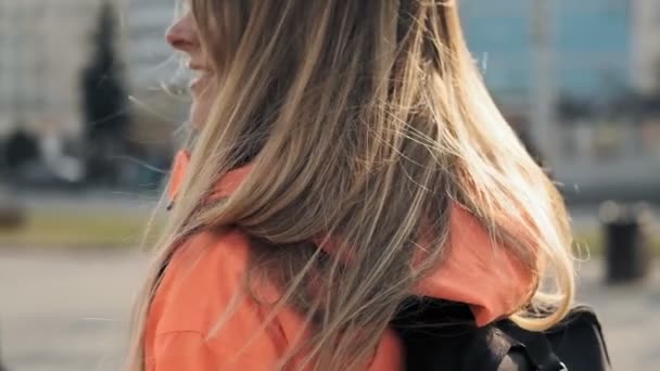 Jonge vrouw kijken naar de camera in slow motion in de stad. Portret van aantrekkelijk meisje — Stockvideo