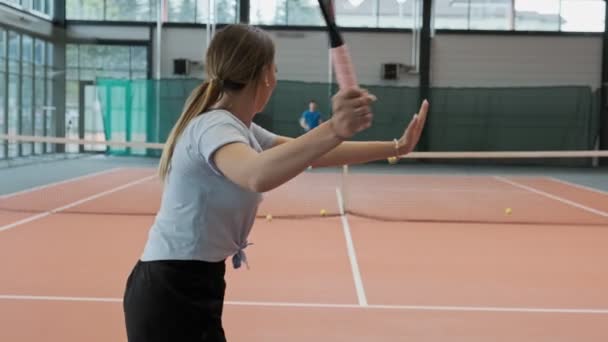 穿着运动服的年轻女子和男人打网球 女子网球选手的中拍 年轻人在慢动作打网球 — 图库视频影像