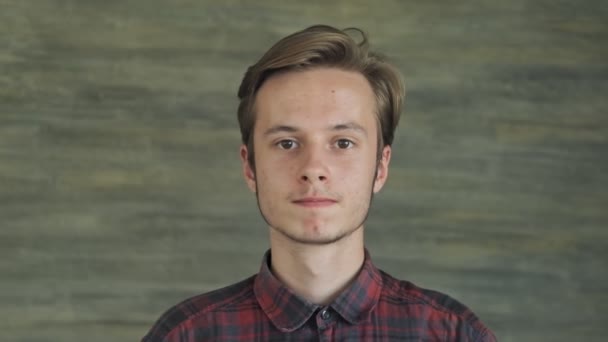 Young man at camera in office. Portrait of handsome causasian guy. Close up view — Stock Video