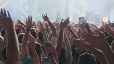 Harika bir müzik konseri izleyen mutlu insanlar. Hayranları ellerini kaldırıp cep telefonuyla fotoğraf çekiyorlar. 4k, Uhd