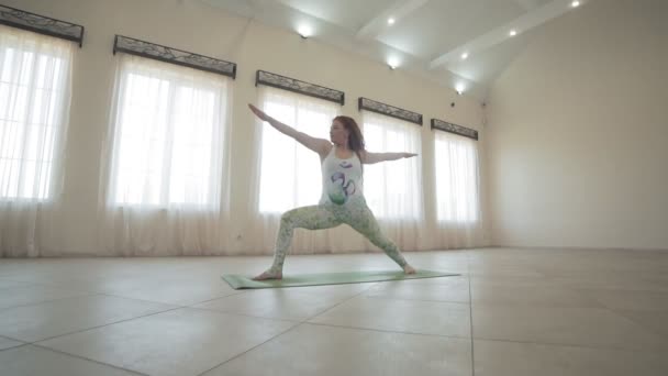 Young Woman Doing Yoga Warrior Pose Light Studio Full Length — Stock Video