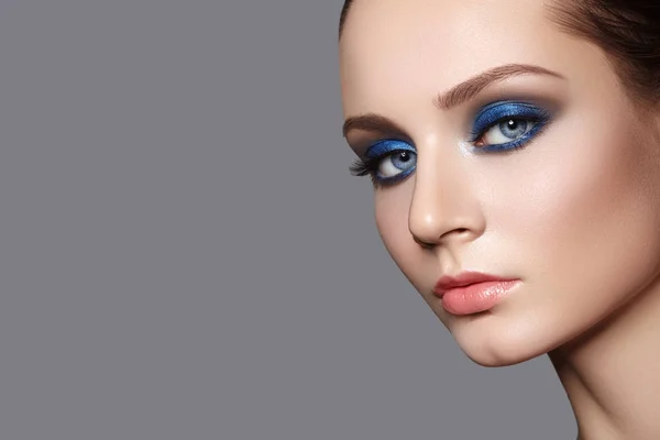 Beautiful Woman with Professional Makeup. Celebrate Style Eye Make-up, Perfect Eyebrows, Shine Skin. Bright Fashion Look.