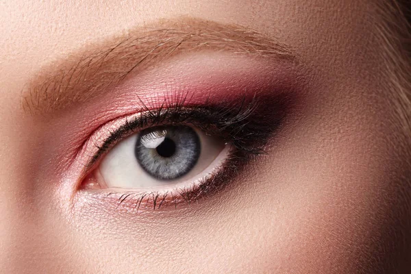 Closeup Macro of Woman Face with Eyes Make-up. Fashion Celebrate Makeup, Glowy Clean Skin. Summer Pink Eyeshadows