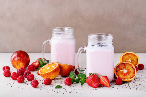 Strawberry smoothie in glass jars