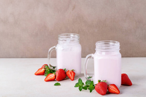 Strawberry smoothie in glass jars