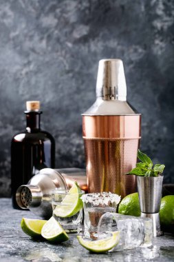 Naneli, limonlu ve tuzlu bir bardakta koyu dokuya servis edilen tekila.