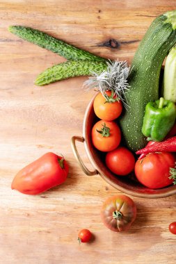 Kahverengi ahşap zemin üzerinde taze kırmızı domatesler. Üst manzara, düz yatış. Boşluğu kopyala