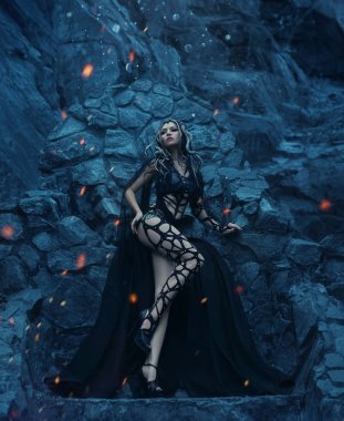 Medusa Gorgona Tanrıça bir bakışları bir taşa dönüm. Bu soğuk, mavi tonlar kayalarda çerçevede duruyor. Bir kız Gotik tarzı tasarımcı kılık, saç tokaları altın yılanlar